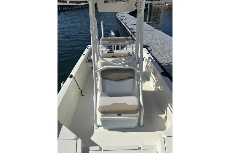 Slide: The Image of 2016 Skeeter SX2250 boat with rear ladder and motor, parked on pavement. - 11