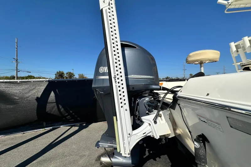 Slide: The Image of 2016 Skeeter SX2250 boat with Yamaha outboard motor, parked under clear blue sky. - 13