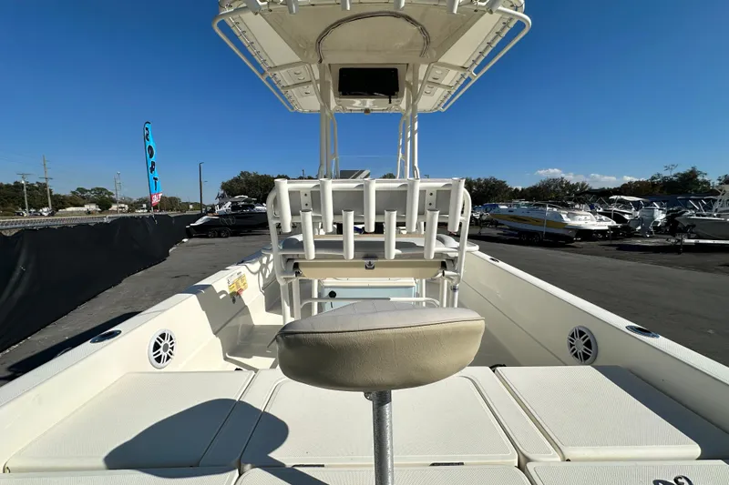 Slide: The Image of 2016 Skeeter SX2250 boat interior with seating and console, parked outdoors under clear blue sky. - 19