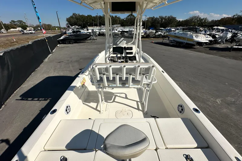 Slide: The Image of 2016 Skeeter SX2250 boat interior with seating and rod holders, parked in a marina. - 20