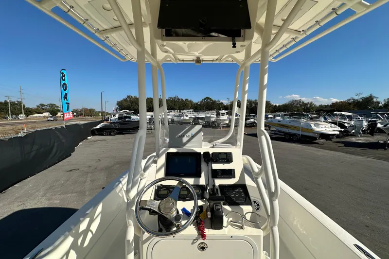 Slide: The Image of 2016 Skeeter SX2250 boat console with steering wheel and electronics at a boat sale. - 26