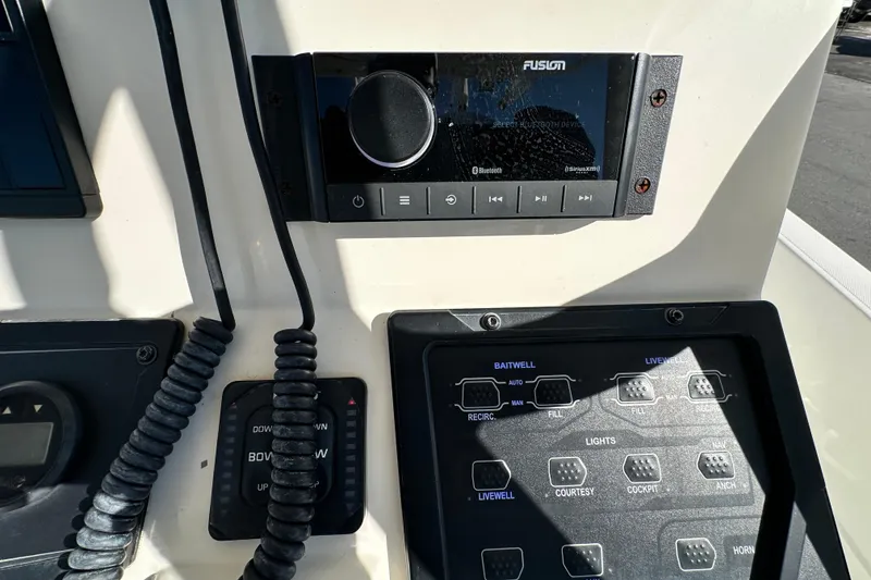 Slide: The Image of Control panel of a 2016 Skeeter SX2250 boat with audio and switch controls. - 36