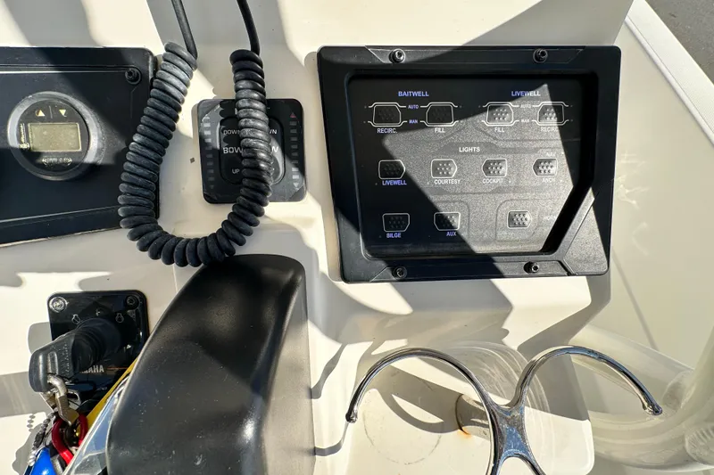 Slide: The Image of Control panel of a 2016 Skeeter SX2250 boat with various switches and gauges. - 37