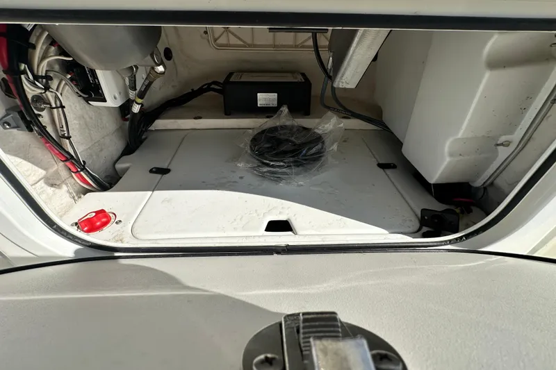 Slide: The Image of 2016 Skeeter SX2250 boat storage compartment with wiring and battery. - 39