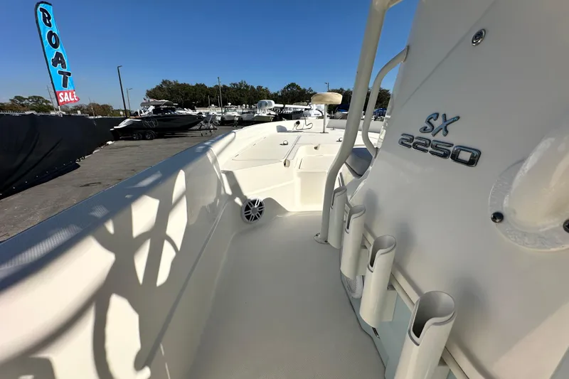 Slide: The Image of 2016 Skeeter SX2250 boat on display at a sales lot, featuring rod holders. - 43