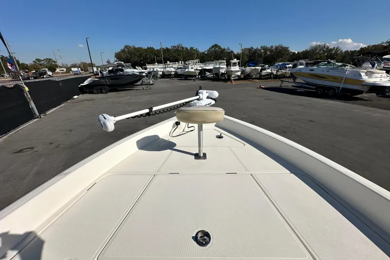 Slide: The Image of 2016 Skeeter SX2250 boat deck with trolling motor, parked in a marina. - 48