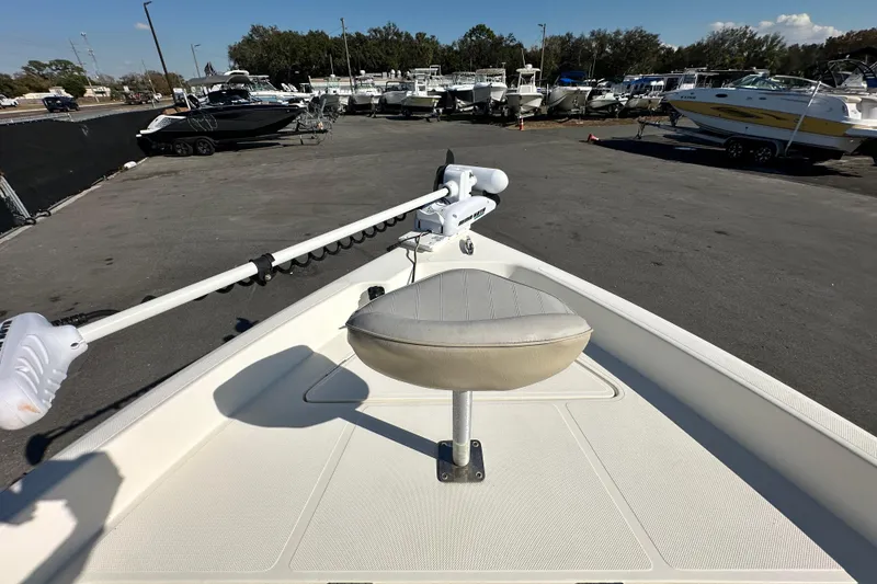 Slide: The Image of 2016 Skeeter SX2250 boat with trolling motor and seat, parked in a marina. - 49