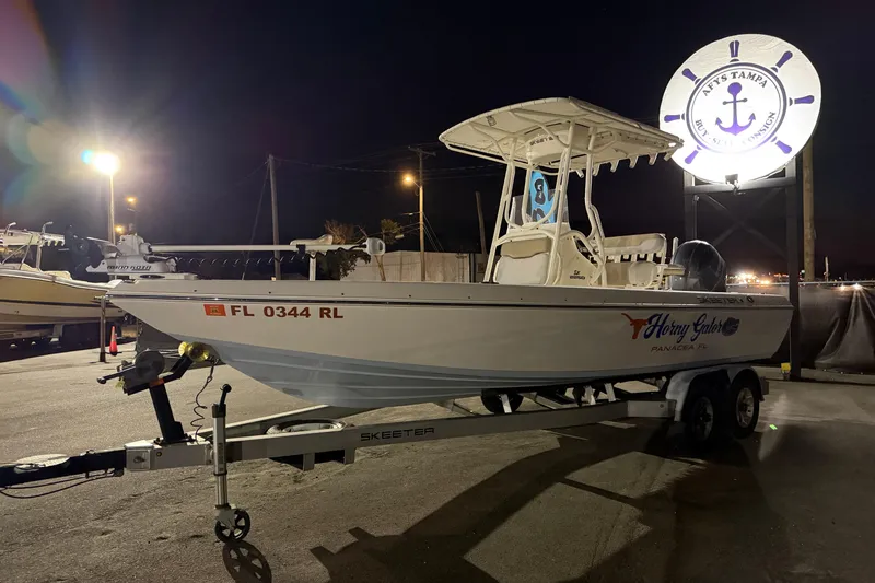 Slide: The Image of 2016 Skeeter SX2250 boat with Yamaha outboard motor on trailer, sunny day. - 5