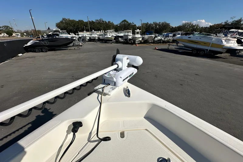 Slide: The Image of 2016 Skeeter SX2250 boat with trolling motor in a marina parking lot. - 50