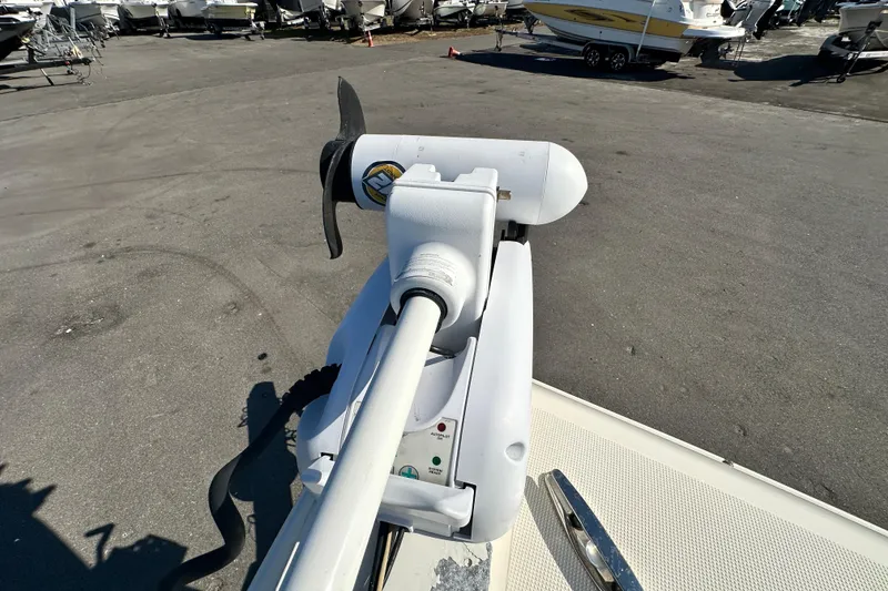 Slide: The Image of 2016 Skeeter SX2250 boat with trolling motor in a marina setting. - 52