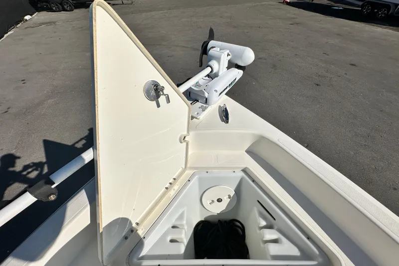 Slide: The Image of 2016 Skeeter SX2250 boat with open storage compartment and trolling motor on deck. - 54