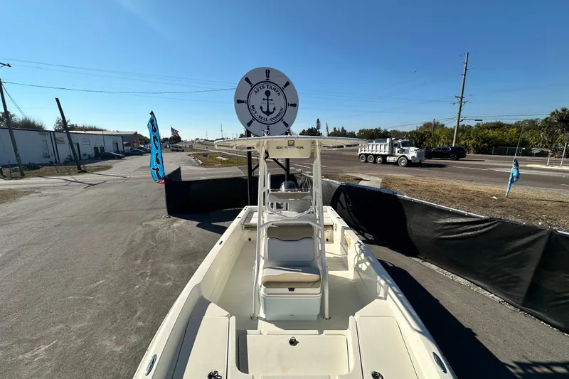 Slide: The Image of 2016 Skeeter SX2250 boat displayed outdoors on a sunny day, with flags and vehicles nearby. - 55