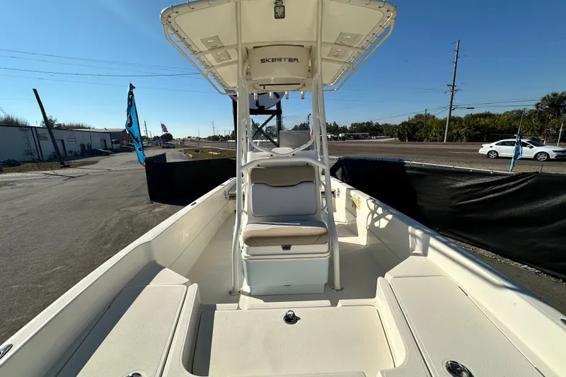 Slide: The Image of 2016 Skeeter SX2250 boat with center console, parked outdoors under clear blue sky. - 59