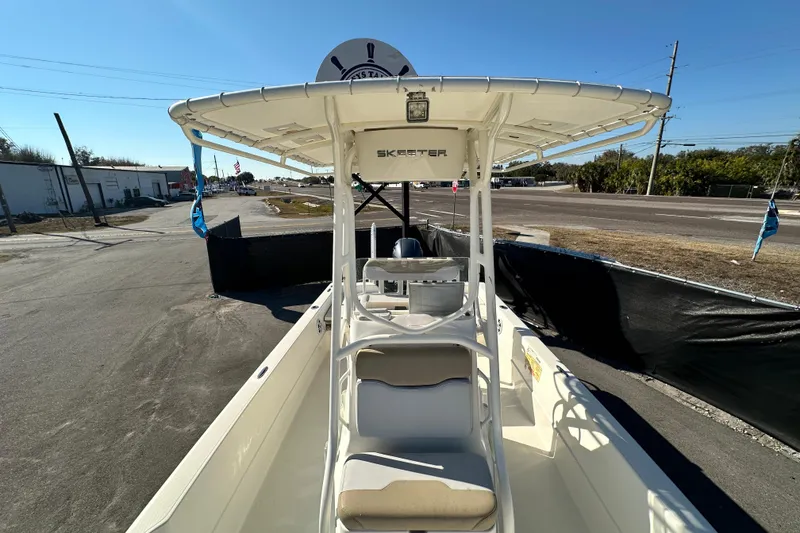 Slide: The Image of 2016 Skeeter SX2250 boat with T-top, parked on a sunny day. - 60