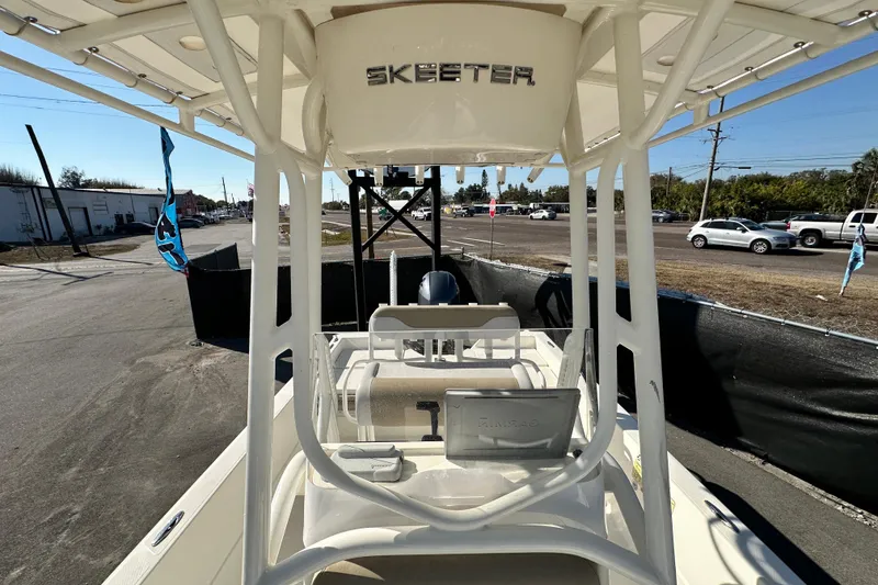 Slide: The Image of 2016 Skeeter SX2250 boat with T-top, parked outdoors on a sunny day. - 64