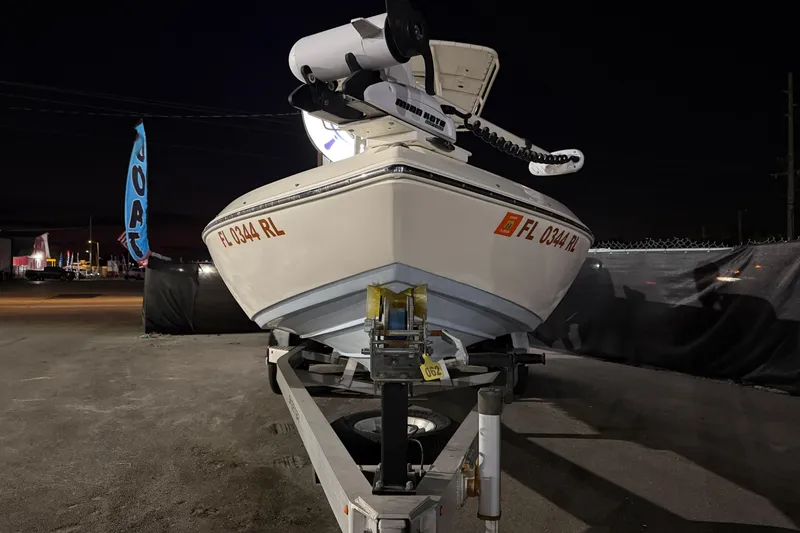 Slide: The Image of 2016 Skeeter SX2250 boat on trailer in outdoor lot under clear blue sky. - 7