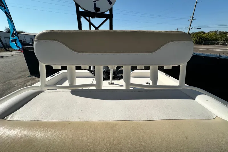 Slide: The Image of 2016 Skeeter SX2250 boat seat with beige and white upholstery, outdoor setting. - 70