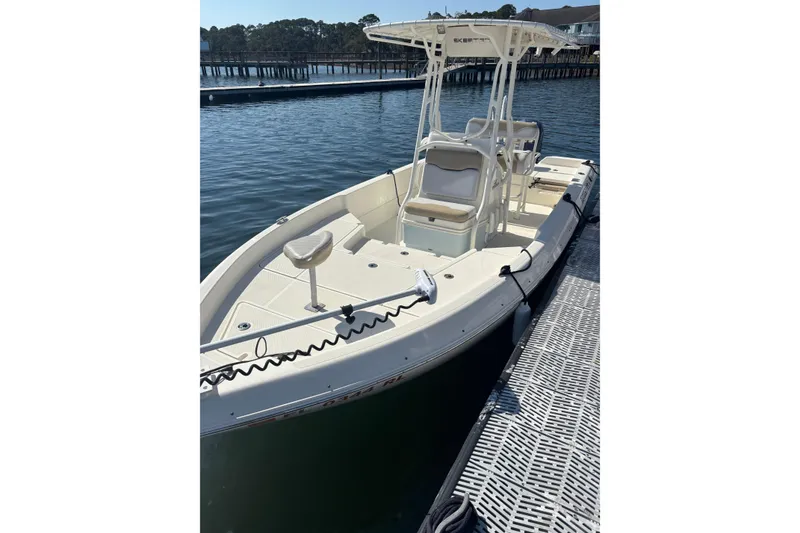 Slide: The Image of 2016 Skeeter SX2250 boat on trailer, parked outdoors under clear blue sky. - 8