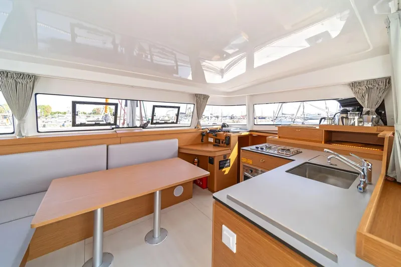 Slide: The Image of Modern interior of 2022 Excess 11 catamaran with kitchen and dining area. - 13