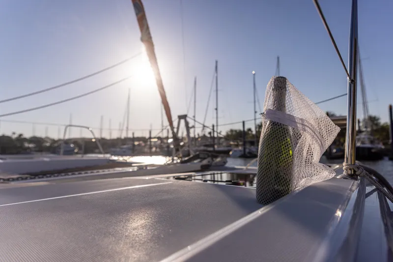 Slide: The Image of Sailboat deck with a bottle in mesh, sunset view, Excess 11, 2022 model. - 17