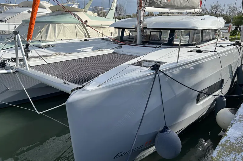 Slide: The Image of 2022 Excess 11 catamaran docked at marina, showcasing sleek design and modern features. - 23