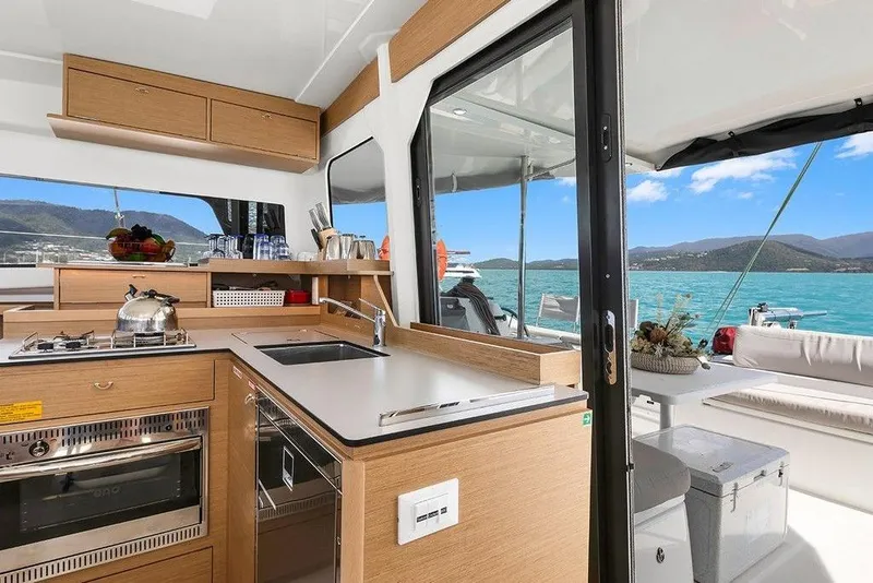 Slide: The Image of Luxurious 2022 Excess 11 yacht interior with modern kitchen and scenic ocean view. - 27