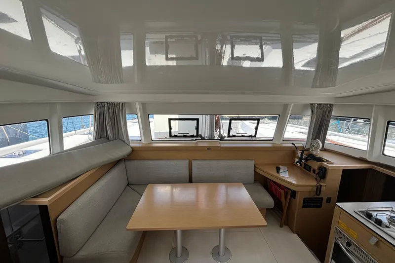 Slide: The Image of Interior of 2022 Excess 11 catamaran with dining area and panoramic windows. - 30