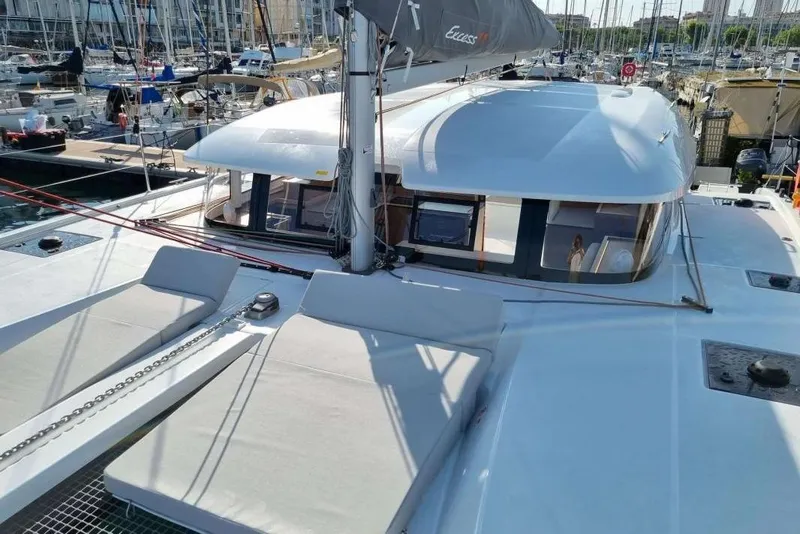 Slide: The Image of 2022 Excess 11 catamaran docked in marina, showcasing sleek design and spacious deck. - 31