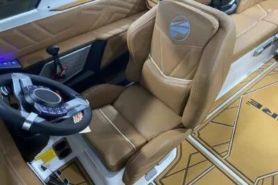 Slide: The Image of 2026 Tigé Ultré 25ZX boat interior with tan leather seating and modern steering wheel. - 11