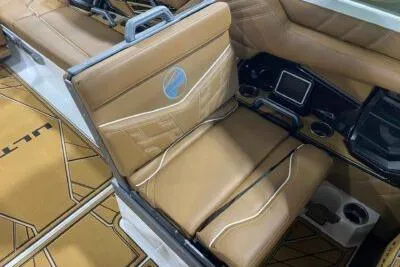Slide: The Image of 2026 Tigé Ultré 25ZX boat interior with tan leather seating and modern dashboard. - 13