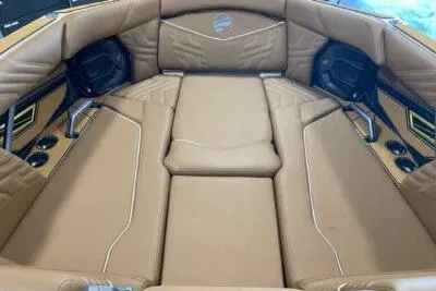 Slide: The Image of 2026 Tigé Ultré 25ZX boat interior with tan leather seating and cup holders. - 14