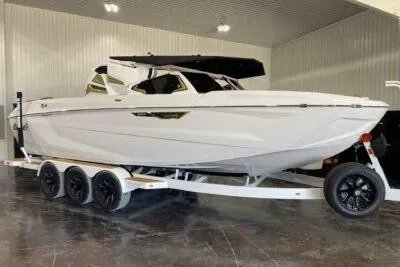 Slide: The Image of 2026 Tigé Ultré 25ZX boat on trailer in indoor showroom. - 3