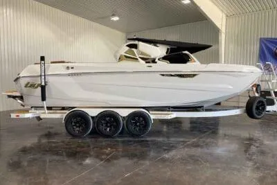 Slide: The Image of 2026 Tigé Ultré 25ZX boat on trailer in indoor showroom. - 4