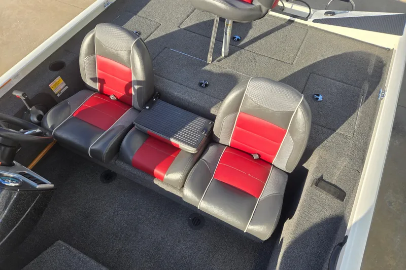 Slide: The Image of 2017 Ranger RT188 boat interior with red and gray seats, steering wheel, and carpeted flooring. - 9