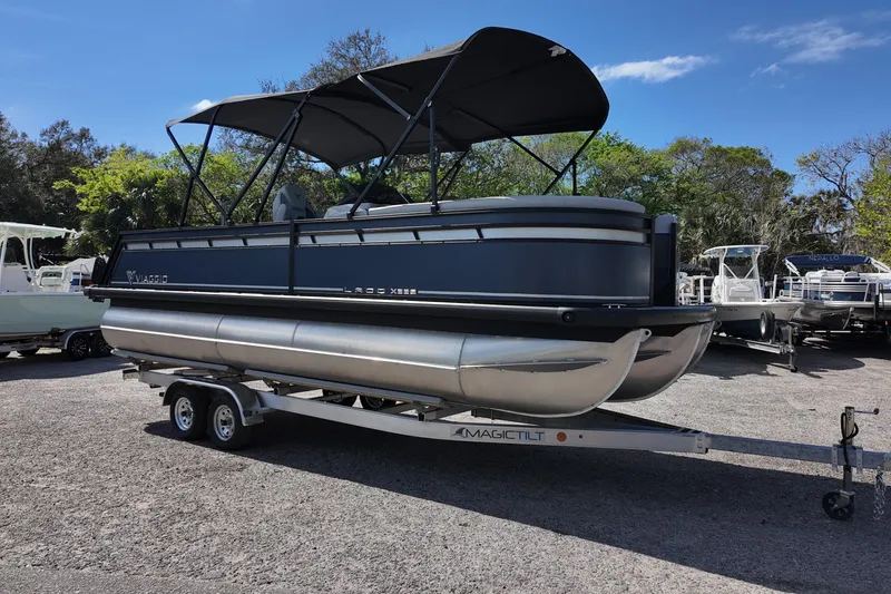 The Image of 2025 Viaggio X22S pontoon boat on trailer, parked outdoors under clear sky. - 0