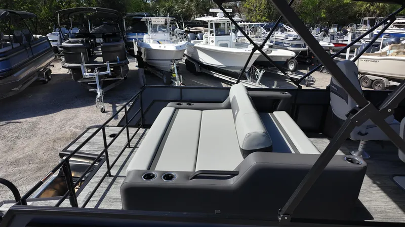 Slide: The Image of 2025 Viaggio X22S boat interior with gray seating, surrounded by various boats in a marina. - 5
