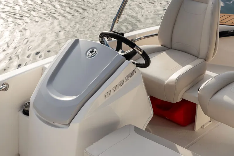 Slide: The Image of Interior of Boston Whaler 130 Super Sport 2026 with steering console. - 24