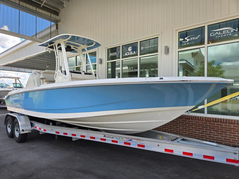 Slide: The Image of 2026 Boston Whaler 250 Dauntless boat on trailer outside a showroom. - 20