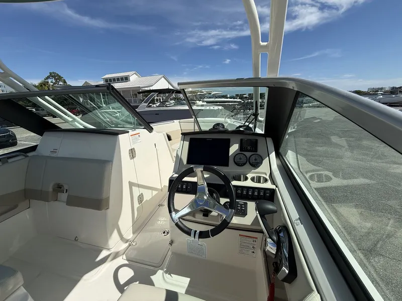 Slide: The Image of The image shows the cockpit of a 2026 Boston Whaler 240 Vantage with modern instruments. - 14