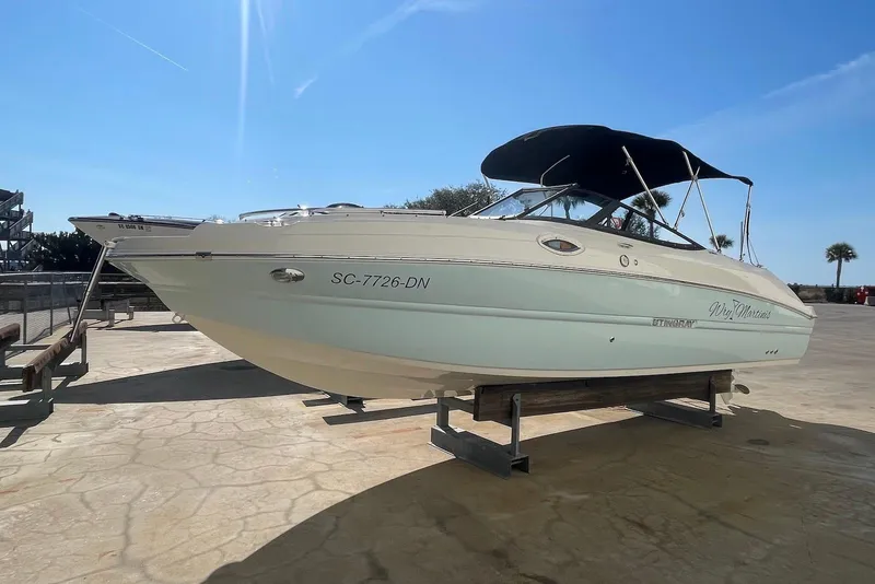 Slide: The Image of 2020 Stingray 231 DC boat on display under clear blue sky. - 2
