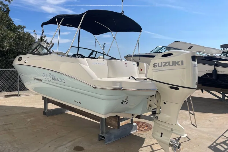 Slide: The Image of 2020 Stingray 231 DC boat with Suzuki outboard motor on display. - 3