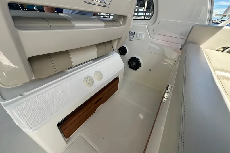 Slide: The Image of Interior view of 2023 Boston Whaler 380 Realm boat, featuring seating and storage compartments. - 12
