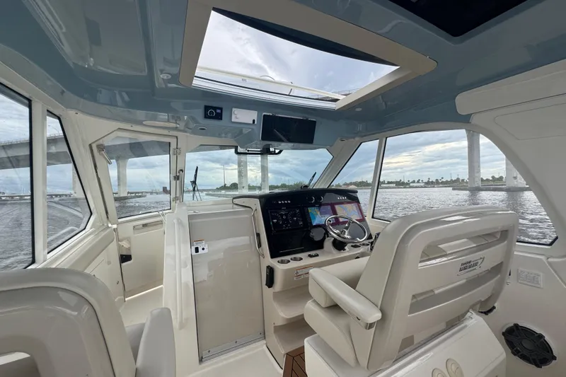 Slide: The Image of Interior view of 2018 Boston Whaler 380 Realm boat cockpit with modern navigation system. - 13