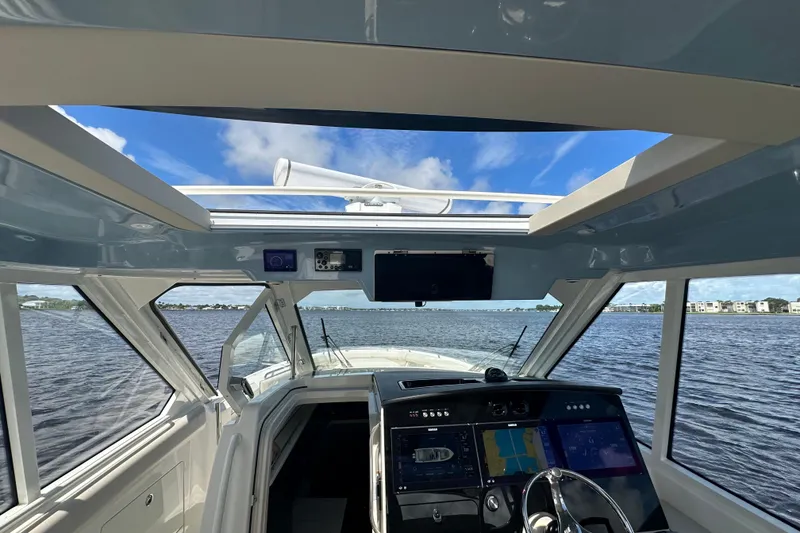 Slide: The Image of Interior view of 2023 Boston Whaler 380 Realm boat, featuring advanced navigation systems. - 16