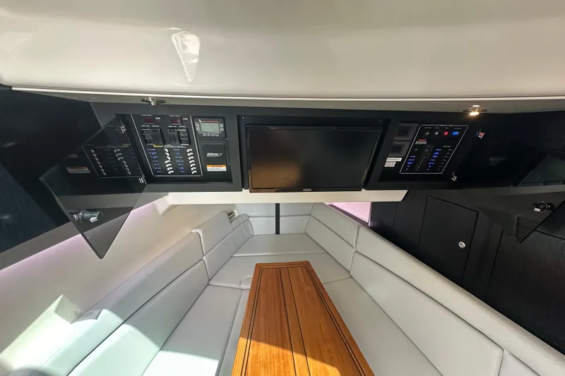 Slide: The Image of 2023 Boston Whaler 380 Realm interior with control panels and seating area. - 22
