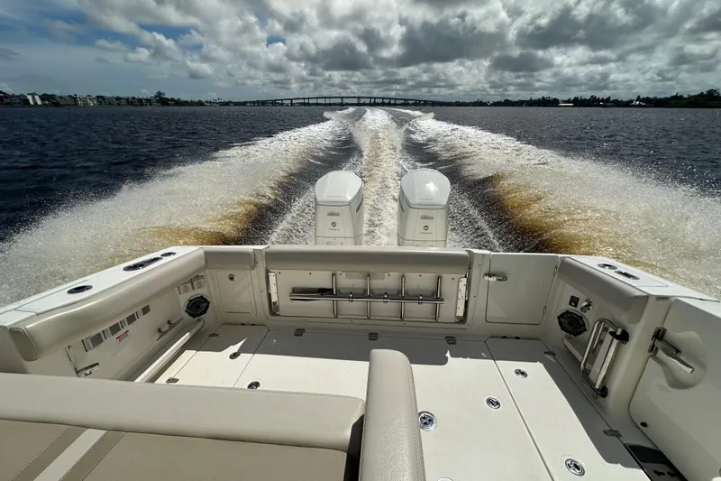 Slide: The Image of 2023 Boston Whaler 380 Realm cruising on open water, showcasing powerful dual engines. - 4