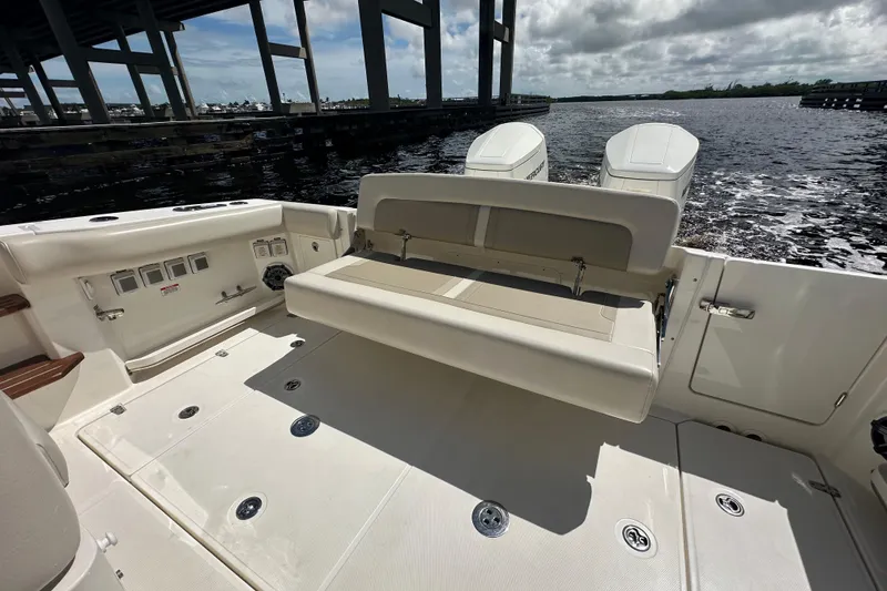 Slide: The Image of 2023 Boston Whaler 380 Realm boat deck with seating and twin engines. - 6