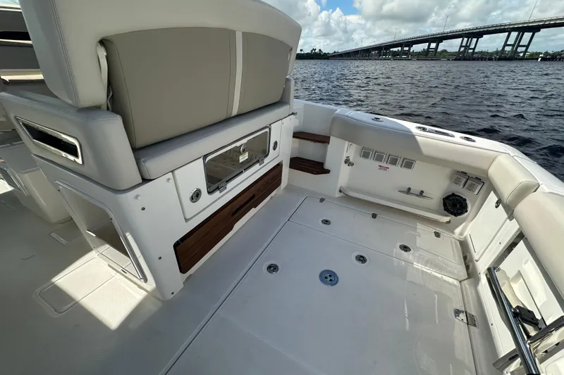 Slide: The Image of 2023 Boston Whaler 380 Realm boat interior with seating and water view. - 8