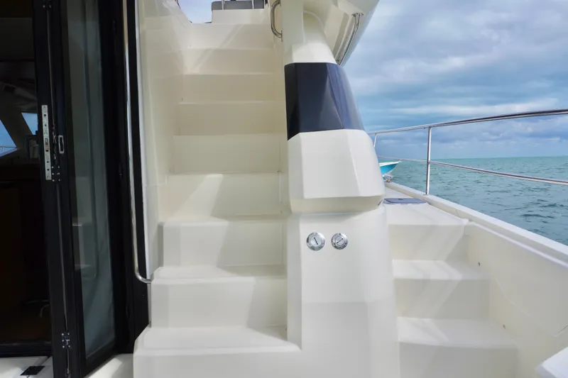 Slide: The Image of Staircase on 2017 Aquila 44 Yacht with ocean view in background. - 12