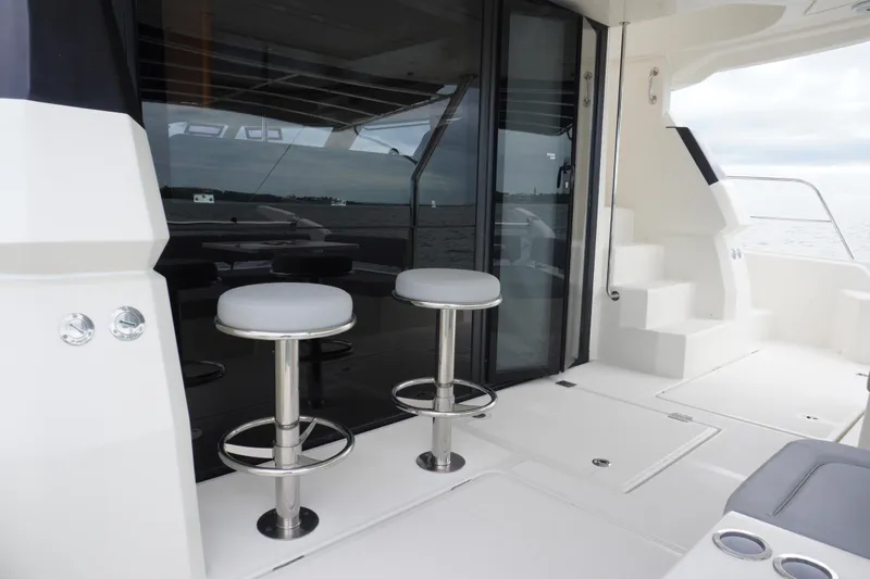 Slide: The Image of 2017 Aquila 44 Yacht deck with bar stools and glass doors. - 15
